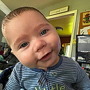 Sammy is registered to the contest to win money with this photo: baby, blanket, blue_eyes, casual, child, closeup, cozy, cute, expression, face, happy, head, home, indoor, infant, person, portrait, smiling, striped_clothing, young