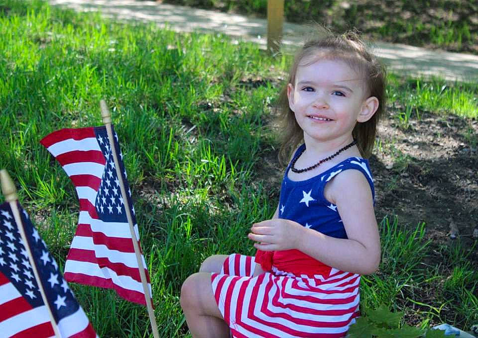 Ava Marie is registered to the contest to win money with this photo: child, flag, flag_day_usa, flag_of_the_united_states, grass, grass_family, holiday, joy, memorial_day, person, plant, summer, toddler, tree, vacation