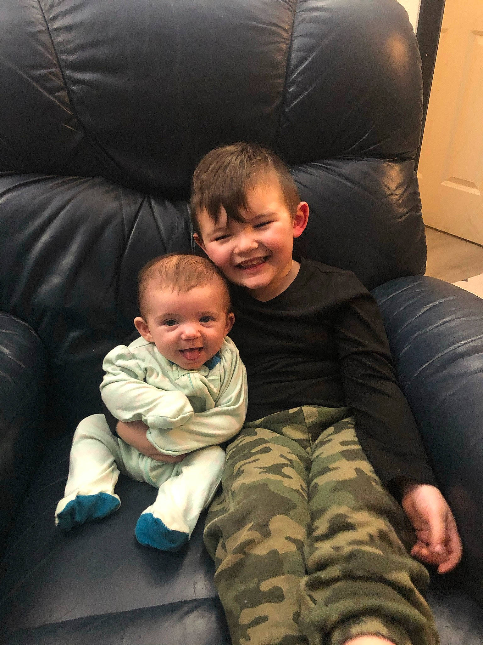 Blayke is registered to the contest to win money with this photo: baby, cheek, child, comfort, eye, facial_expression, flash_photography, foot, fun, hairstyle, human_leg, interaction, joy, lap, leg, mouth, person, sitting, skin, smile