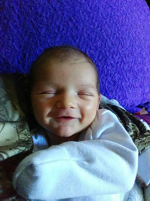 Bentley is registered to the contest to win money with this photo: baby, baby_toddler_clothing, cheek, child, chin, comfort, eyebrow, fun, happy, iris, linens, lip, magenta, mouth, nose, person, purple, skin, smile, toddler