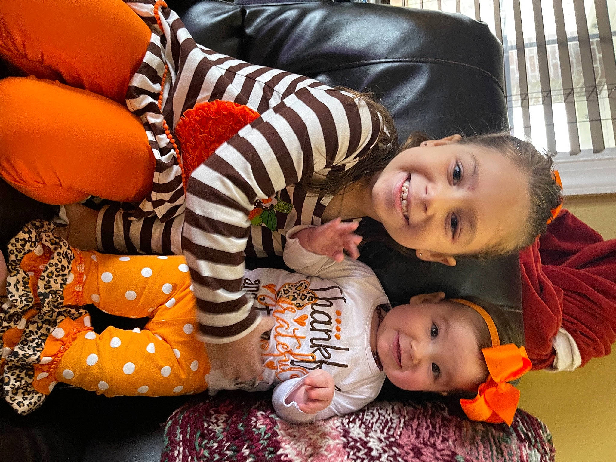 Estelle is registered to the contest to win money with this photo: baby, baby_toddler_clothing, child, comfort, couch, eye, face, headwear, joy, laugh, living_room, nose, orange, person, studio_couch, toddler, tooth