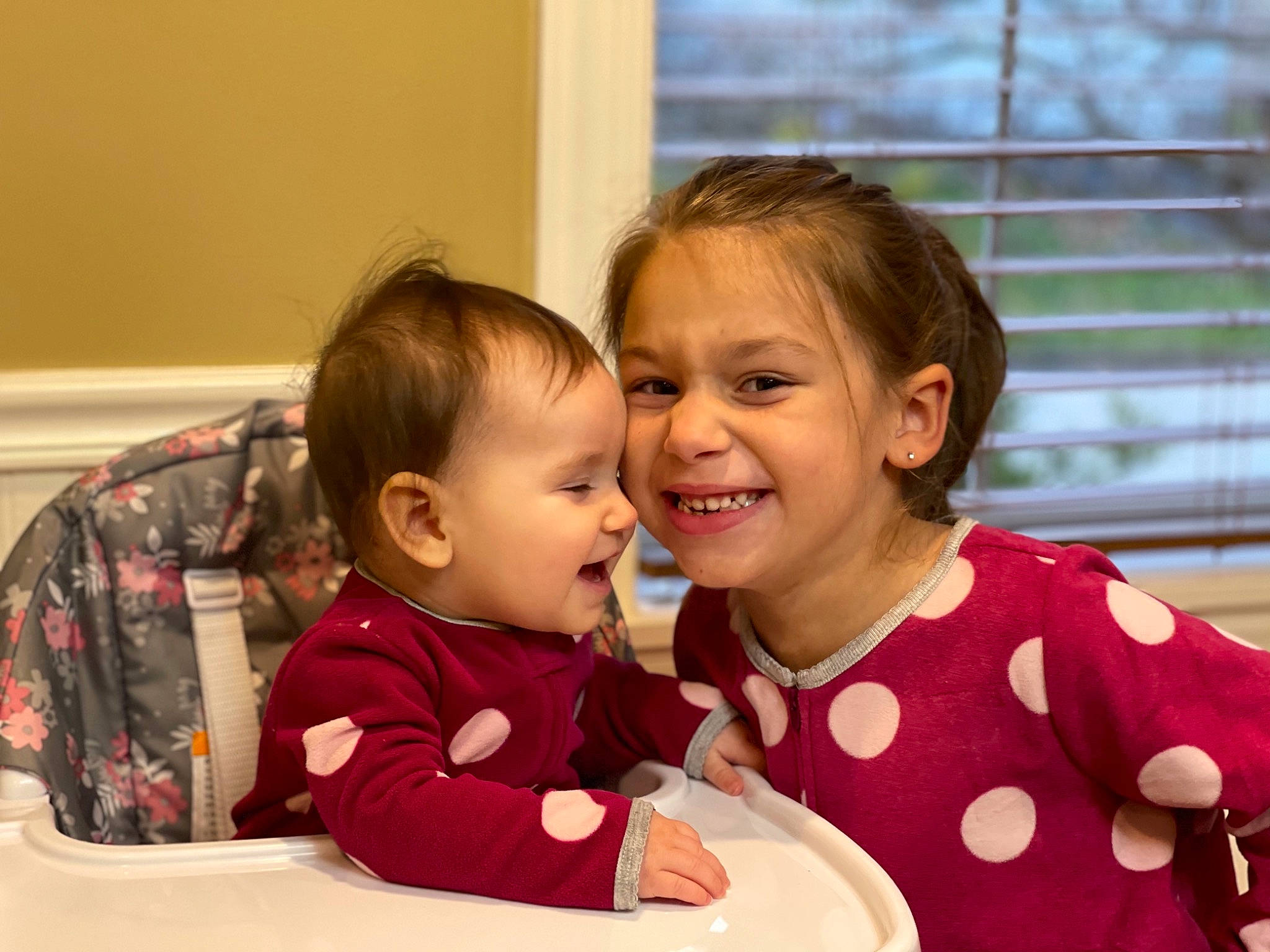 Mia is registered to the contest to win money with this photo: baby, baby_toddler_clothing, cheek, child, comfort, ear, eye, facial_expression, happy, interaction, joy, laugh, love, mouth, nose, person, plaid, toddler, tooth