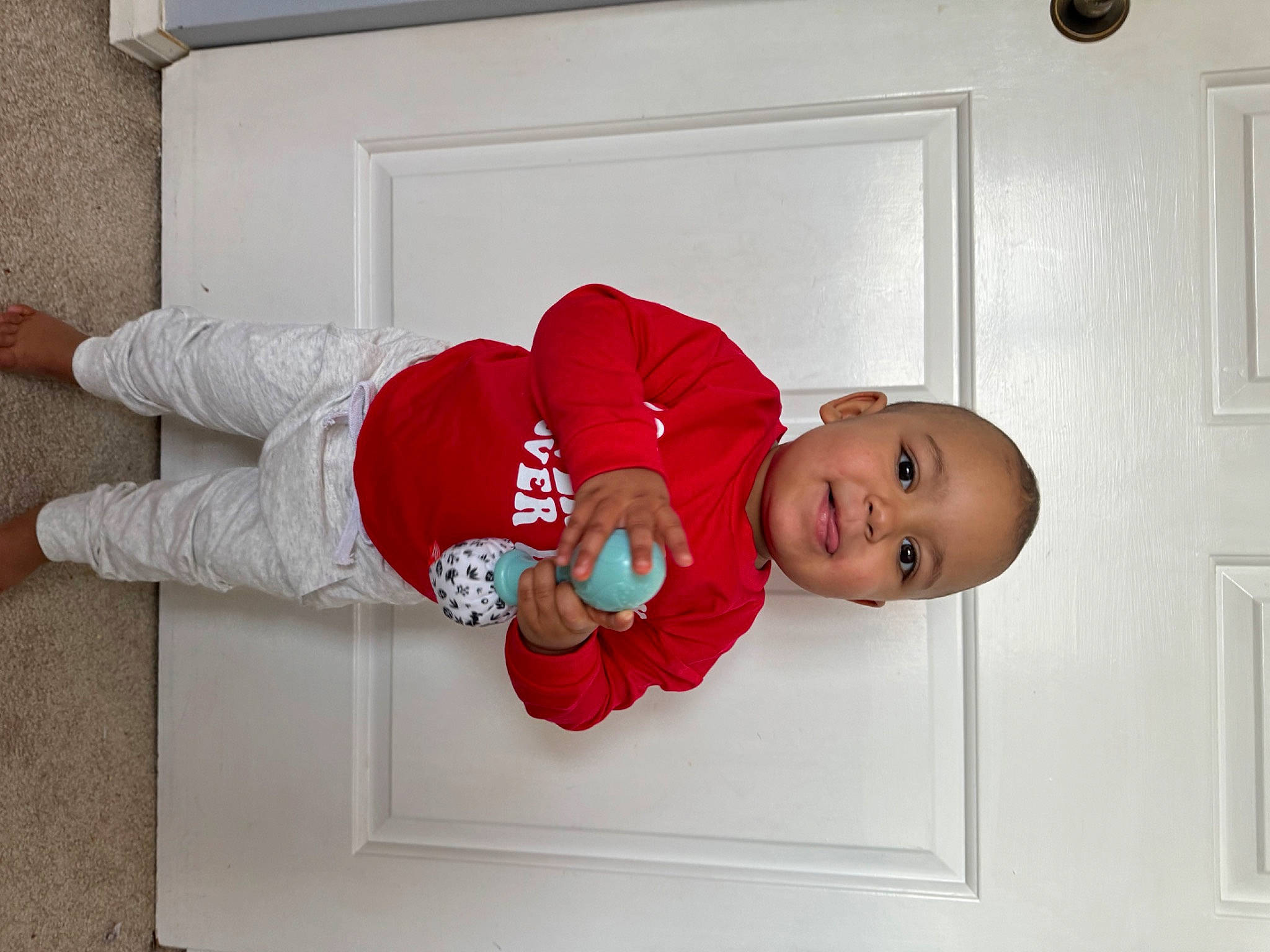 Drayson joined the competition — help win amazing prizes! baby, baby_safety, baby_toddler_clothing, carmine, child, comfort, door, elbow, flooring, foot, human_leg, joy, knee, person, room, sitting, sleeve, smile, sock, thigh