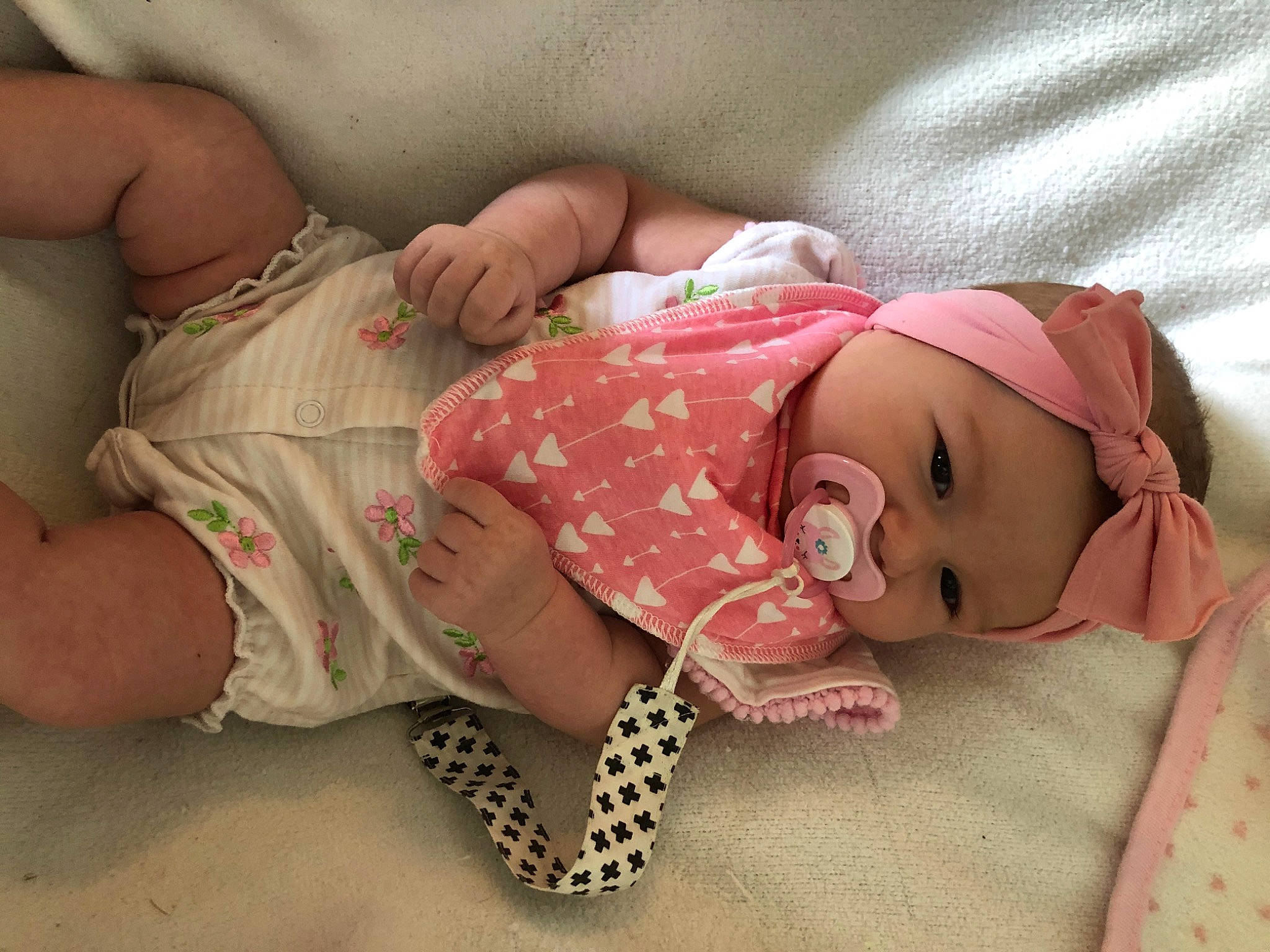 Lexi is registered to the contest to win money with this photo: baby, baby_products, baby_sleeping, baby_toddler_clothing, birth, cheek, child, fashion_accessory, hair_accessory, hand, head, headgear, headwear, pattern, person, pink, product, skin, toddler