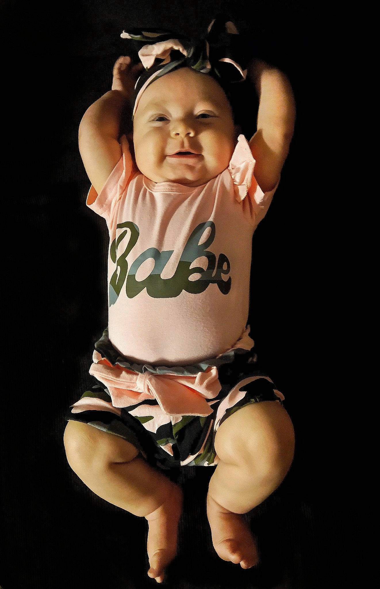 Kirra is registered to the contest to win money with this photo: abdomen, arm, baby, baby_toddler_clothing, entertainment, face, finger, flash_photography, gesture, hand, happy, leg, person, shoulder, sleeve, stomach, t_shirt, thigh, thumb, toddler