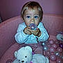 baby, blue_eyes, child, pink, play_area, plastic_ball, teddy_bear, toy, stuffed_animal, blanket, cozy, indoor, cute, infant, childhood, happy, person, soft_texture, plush, seated