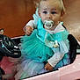 toddler, child, toy_car, pacifier, dress, tutu, butterfly_clip, blonde_hair, blue_eyes, indoor, floor, pink, blue, purple, sitting, cute, young_child, play, vehicle, clothing