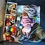 baby, sleeping, playpen, toys, stuffed_animals, blanket, quilt, soft_toys, child, indoor, peaceful, cozy, colorful, pink_clothing, sock, wooden_toy, ball, elephant_toy, striped_toy, pastel_colors