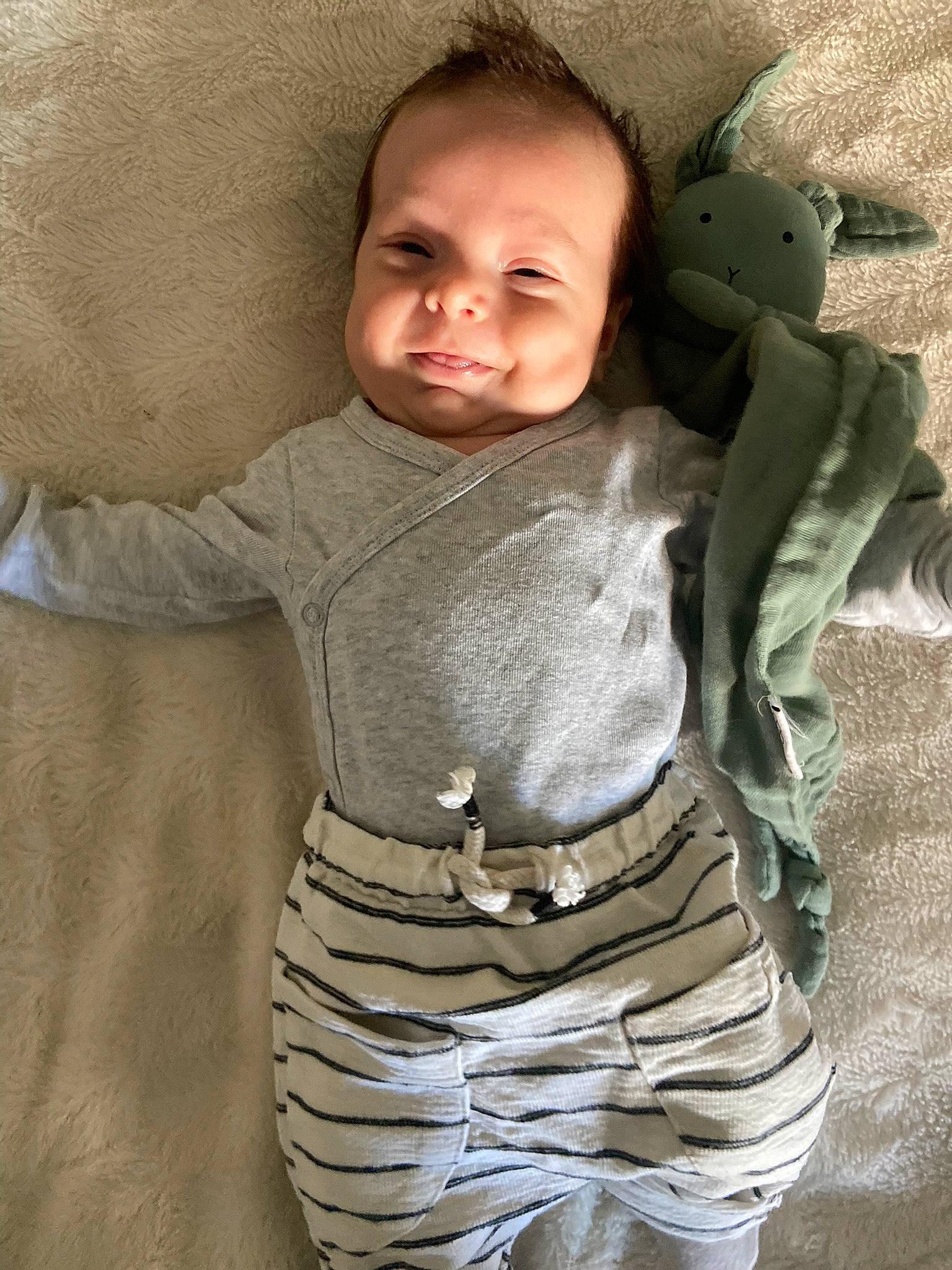 Gaby participe au concours pour gagner de l'argent avec cette photo : arm, baby, baby_toddler_clothing, cheek, comfort, eye, face, gesture, hand, head, human_body, neck, nose, outerwear, person, skin, sleeve, smile, standing, textile