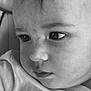 child, baby, face, close_up, black_and_white, portrait, eyes, skin, expression, curious, young, person, soft_lighting, texture, innocence, clothing, head, cheek, nose, eyelashes