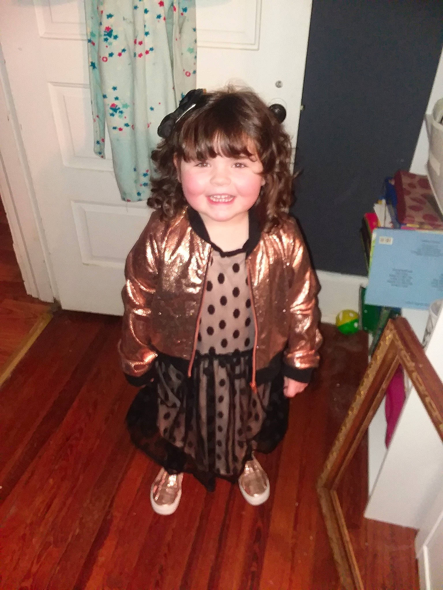 Amya is registered to the contest to win money with this photo: brown_hair, child, costume, joy, outerwear, person, smile, toddler