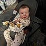 baby, bouncer, babybjorn, toy, wooden_toy, flower_toy, onesie, paw_print, smiling, infant, indoor, carpet, child, cute, happy, seat, baby_gear, home, face, person
