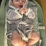 baby, smiling, hooded_towel, infant, cushion, changing_pad, cozy, happy, skin, legs, feet, indoors, child, cute, soft_texture, wrapped, clothing, pacifier, relaxing, portrait