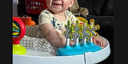Silas joined the competition — help win amazing prizes! baby, walker, toy, smiling, indoor, clothing, socks, furniture, laundry, person, child, play, happy, standing, face, head, home, carpet, colorful, cute