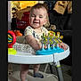 Silas joined the competition — help win amazing prizes! baby, walker, toy, smiling, indoor, clothing, socks, furniture, laundry, person, child, play, happy, standing, face, head, home, carpet, colorful, cute