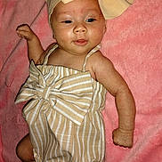 Caityy is registered to the contest to win money with this photo: baby, infant, child, striped_outfit, headband, bow, pink_blanket, lying_down, cute, smiling, skin, arm, legs, closeup, portrait, indoor, soft_texture, fabric, playful, adorable