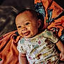 Caityy joined the competition — help win amazing prizes! baby, infant, smiling, tongue_out, blanket, floral_onesie, cute, child, playful, lying_down, happy, indoors, skin, head, face, expression, warm_lighting, cozy, comfort, closeup