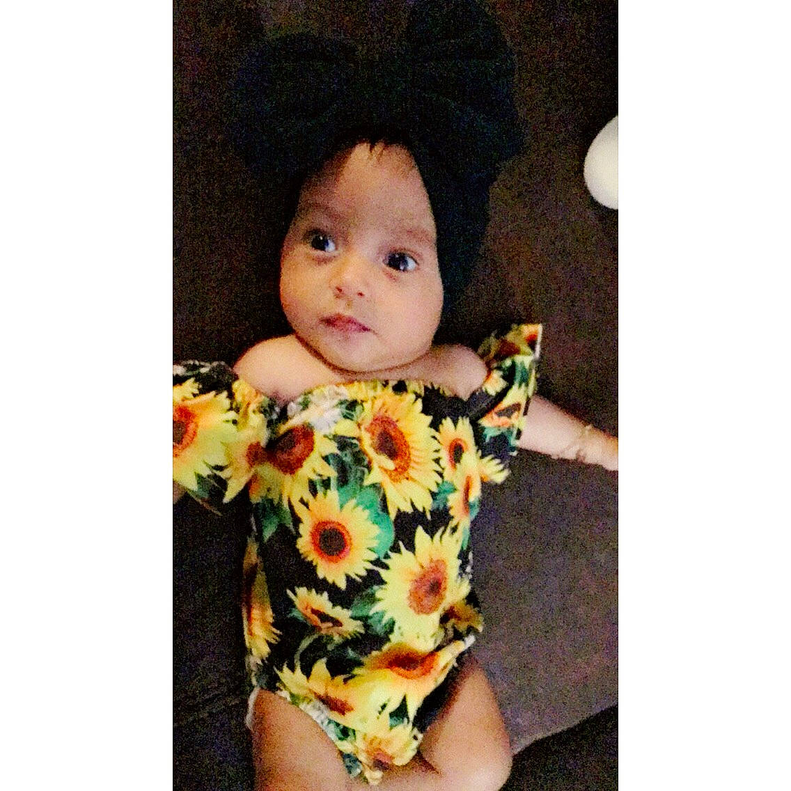 Mila Rose is registered to the contest to win money with this photo: arm, baby, child, design, doll, dress, ear, face, flower, head, headgear, outerwear, pattern, person, plant, product, sleeve, t_shirt, toddler, yellow