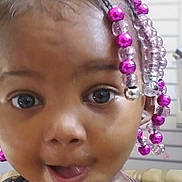 Oshealaya Guzman is registered to the contest to win money with this photo: baby, beaded_hair, blurred_background, braided_hair, child, close_up, clothing, curious, eyes, face, happy, indoor, jewelry, open_mouth, photography, pink_beads, portrait, seated, smiling, toddler