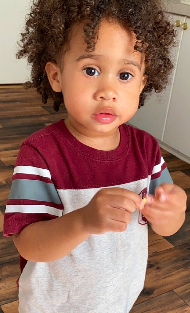 Amari joined the competition — help win amazing prizes! baby, brown_hair, cheek, child, child_model, face, gesture, hair, hairstyle, lip, nose, person, play, smile, standing, t_shirt, toddler