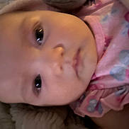 Leelee is registered to the contest to win money with this photo: baby, infant, face, pink_clothing, butterfly_pattern, closeup, portrait, child, cute, eyes, skin, head, baby_girl, soft_lighting, expression, young_child, indoors, person, warm_colors, wearing