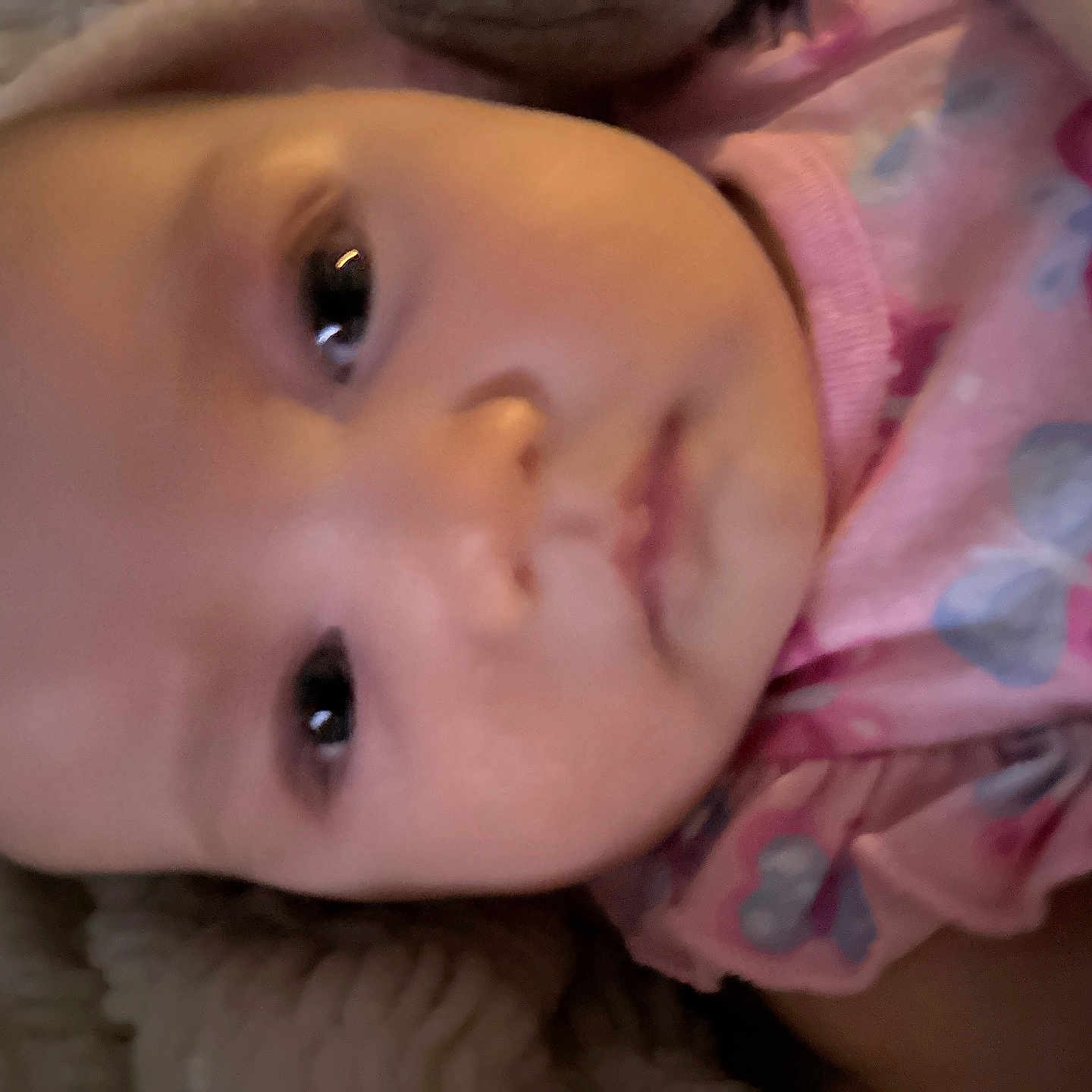 Leelee is registered to the contest to win money with this photo: baby, infant, face, pink_clothing, butterfly_pattern, closeup, portrait, child, cute, eyes, skin, head, baby_girl, soft_lighting, expression, young_child, indoors, person, warm_colors, wearing