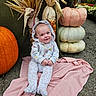 Grace joined the competition — help win amazing prizes! baby, child, infant, smiling, portrait, autumn, fall, pumpkins, gourds, corn_stalks, decorative_corn, flowers, garden, outdoor, blanket, pink_blanket, hooded_outfit, seated, harvest, seasonal_decoration