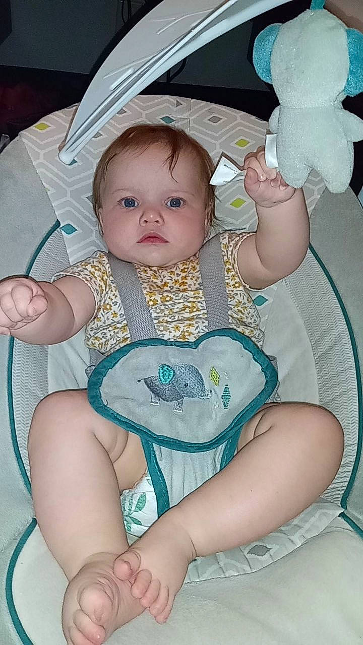 Isabella is registered to the contest to win money with this photo: baby, baby_products, baby_toddler_clothing, chair, cheek, child, circle, comfort, foot, happy, iris, lap, linens, pattern, person, pink, sitting, skin, thigh, toddler