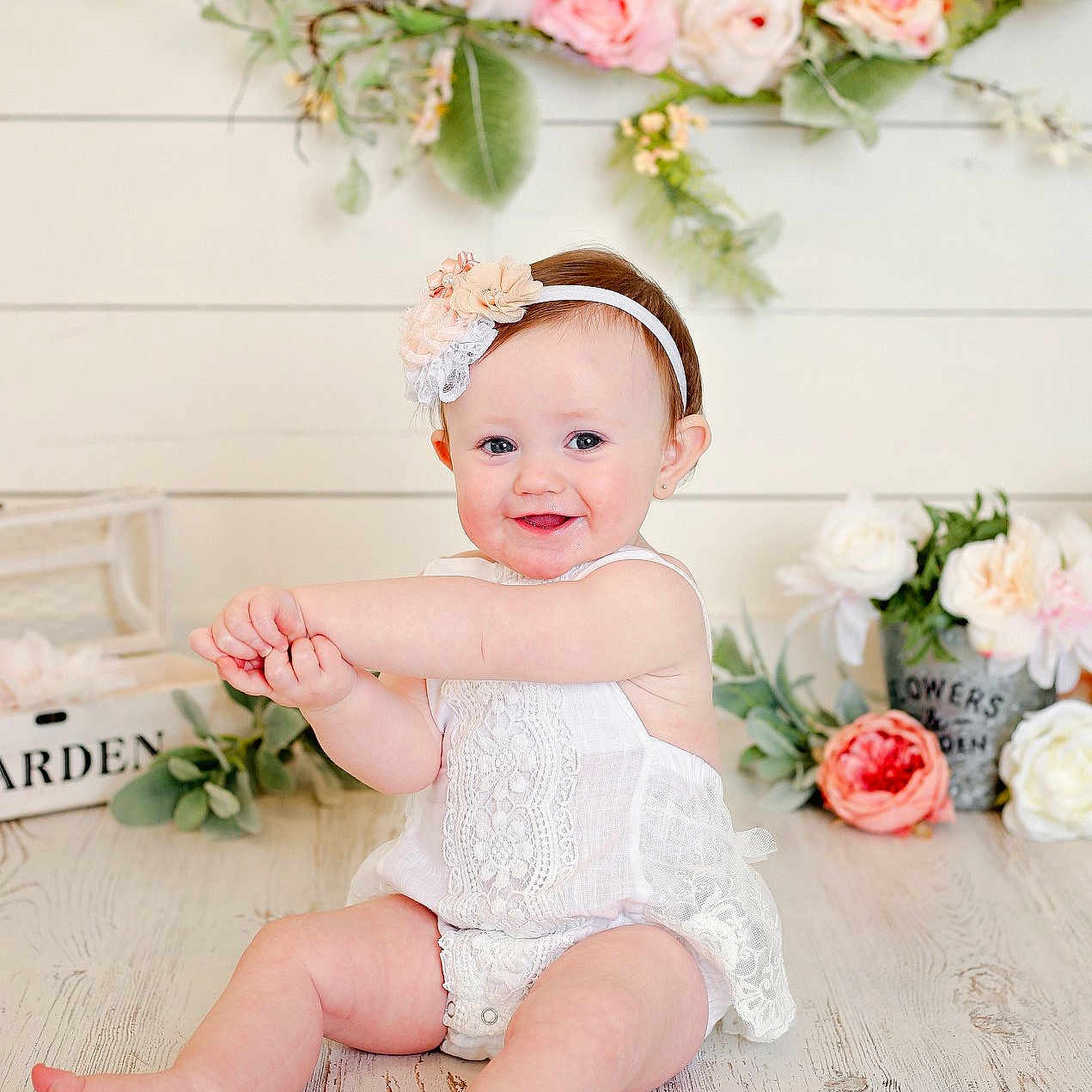 Harlyn is registered to the contest to win money with this photo: baby, baby_toddler_clothing, child, crown, dress, fashion_accessory, flower, hair_accessory, happy, headband, headgear, headpiece, joy, person, petal, photograph, pink, plant, room, textile