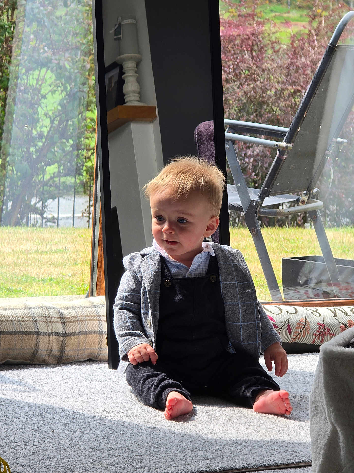 Kayden is registered to the contest to win money with this photo: toddler, child, baby, indoor, carpet, mirror, sunlight, barefoot, clothing, jacket, pants, window, reflection, furniture, chair, grass, outdoor, home, portrait, cute