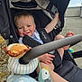 Kayden joined the competition — help win amazing prizes! baby, stroller, toy, blanket, outdoor, child, happy, smile, face, hand, foot, canopy, plush_toy, seatbelt, clothing, sunlight, person, infant, playful, comfort