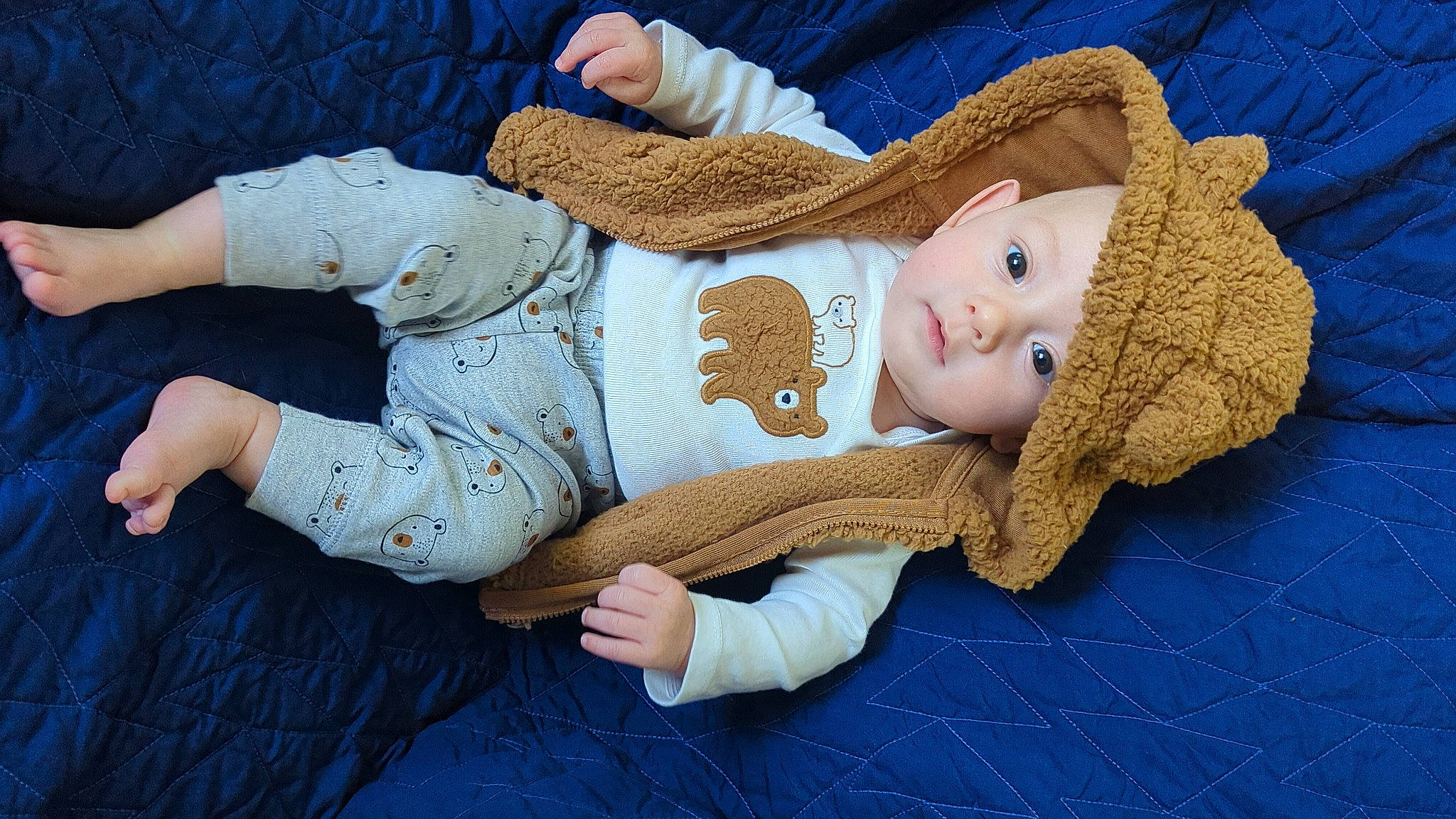 Dawson is registered to the contest to win money with this photo: art, baby, baby_sleeping, baby_toddler_clothing, child, comfort, eye, face, finger, head, headwear, human_body, knit_cap, linens, pattern, person, skin, sleeve, wood, wool