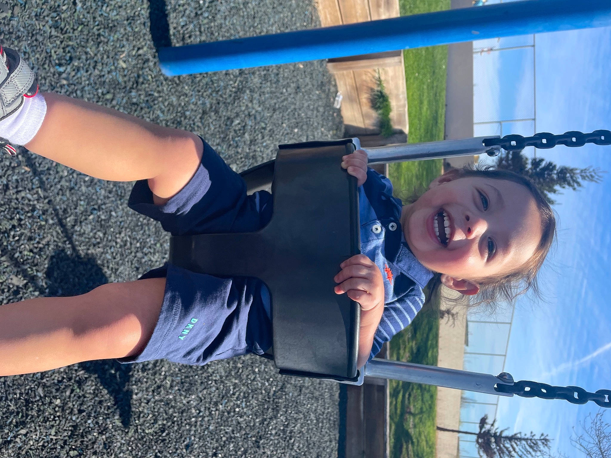 Victor is registered to the contest to win money with this photo: beauty, blue, cool, elbow, electric_blue, fun, happy, human_body, human_leg, knee, leisure, person, plant, shorts, sky, snapshot, sock, sportswear, thigh, toddler