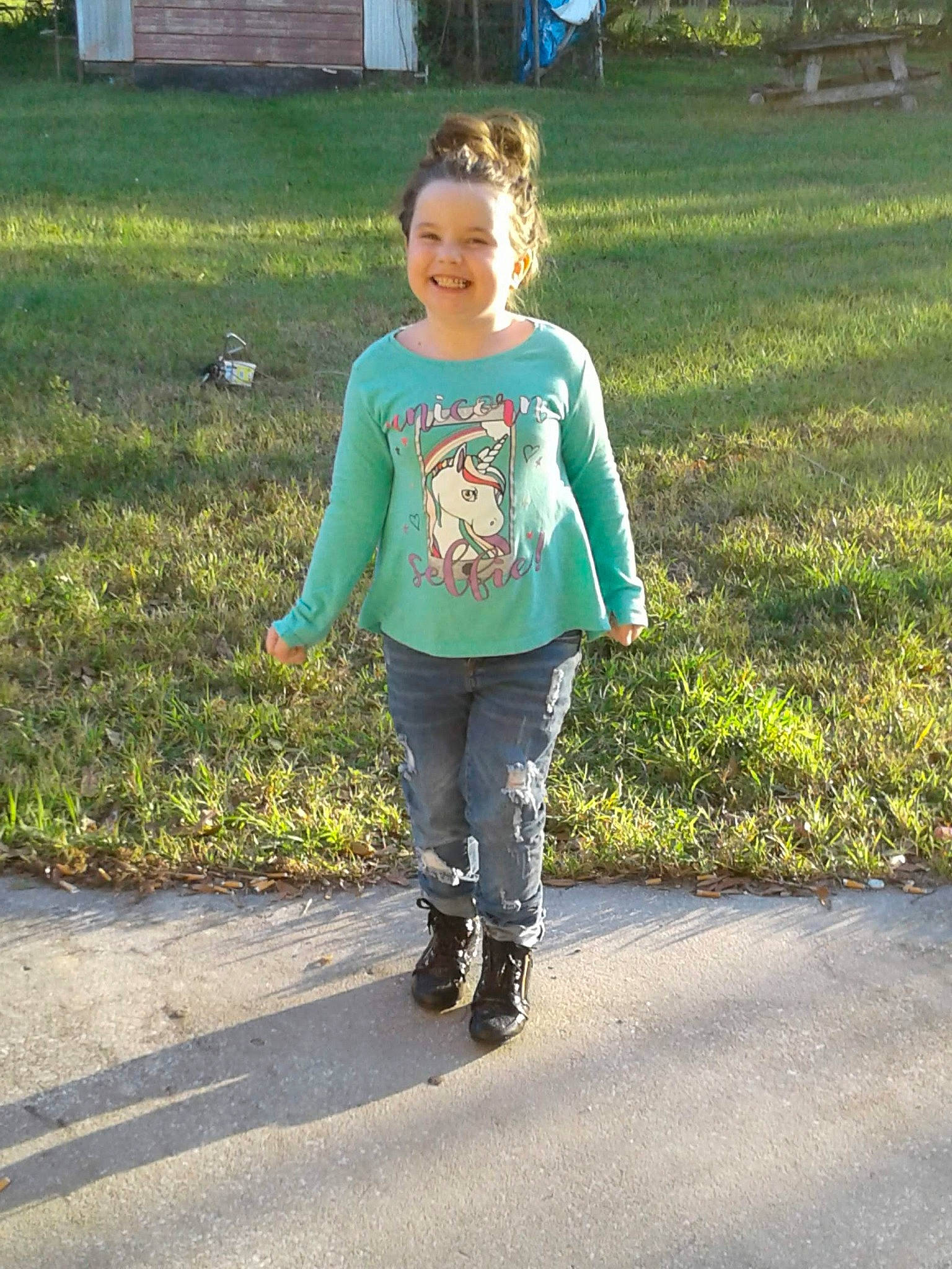 Kyleigh is registered to the contest to win money with this photo: footwear, grass, green, jeans, joy, leggings, outerwear, person, shoe, sleeve, t_shirt, trousers, walking