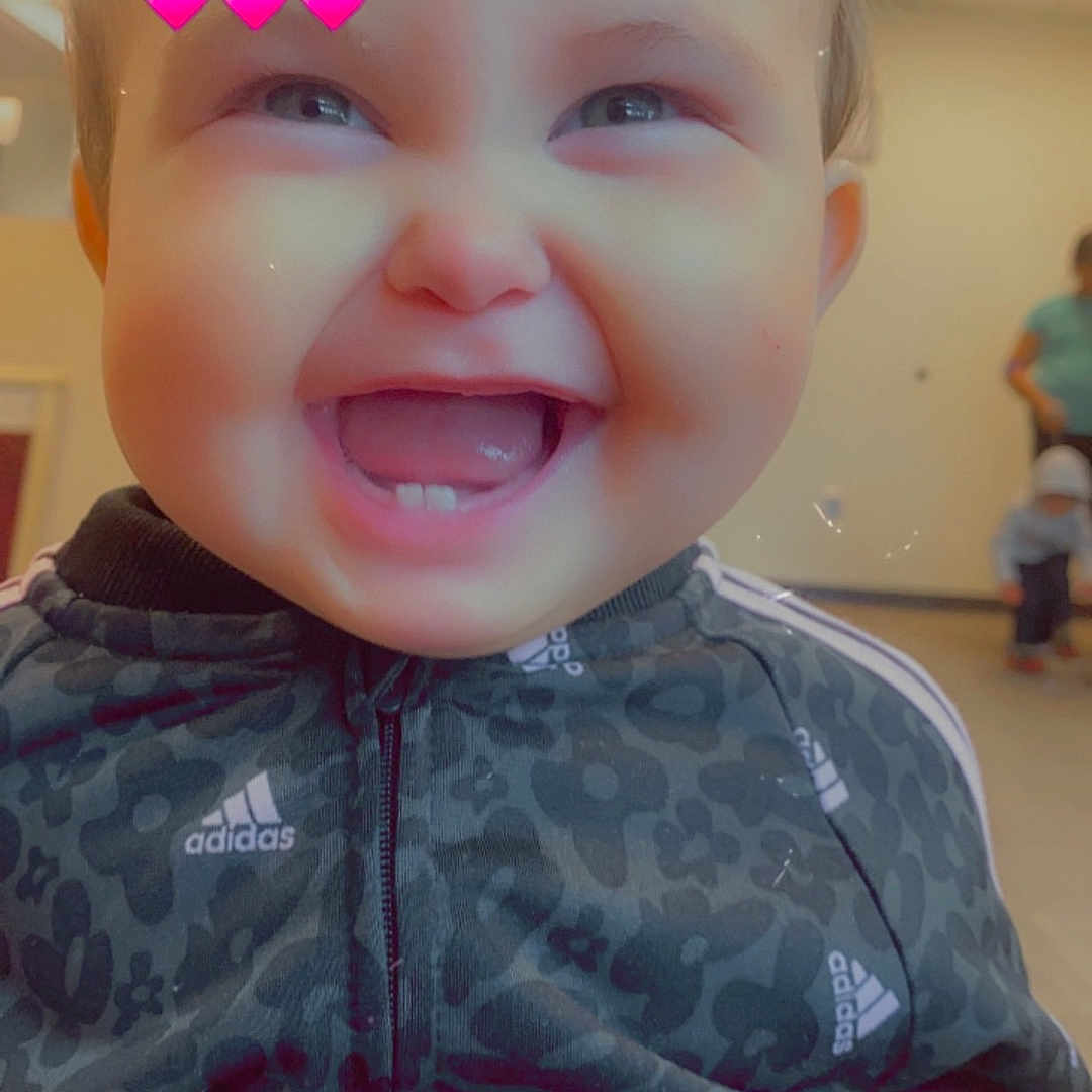 Amanda joined the competition — help win amazing prizes! baby, babylaughing, bodypart, clothing, coat, face, happy, head, jacket, jeans, knitwear, laughing, mouth, pants, person, photography, portrait, smile, sweater, teeth