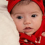 Sofia is registered to the contest to win money with this photo: baby, infant, headband, red_clothing, red_bow, blanket, face, closeup, portrait, cute, soft_texture, child, newborn, skin, eyes, mouth, expression, warm, cozy, photography