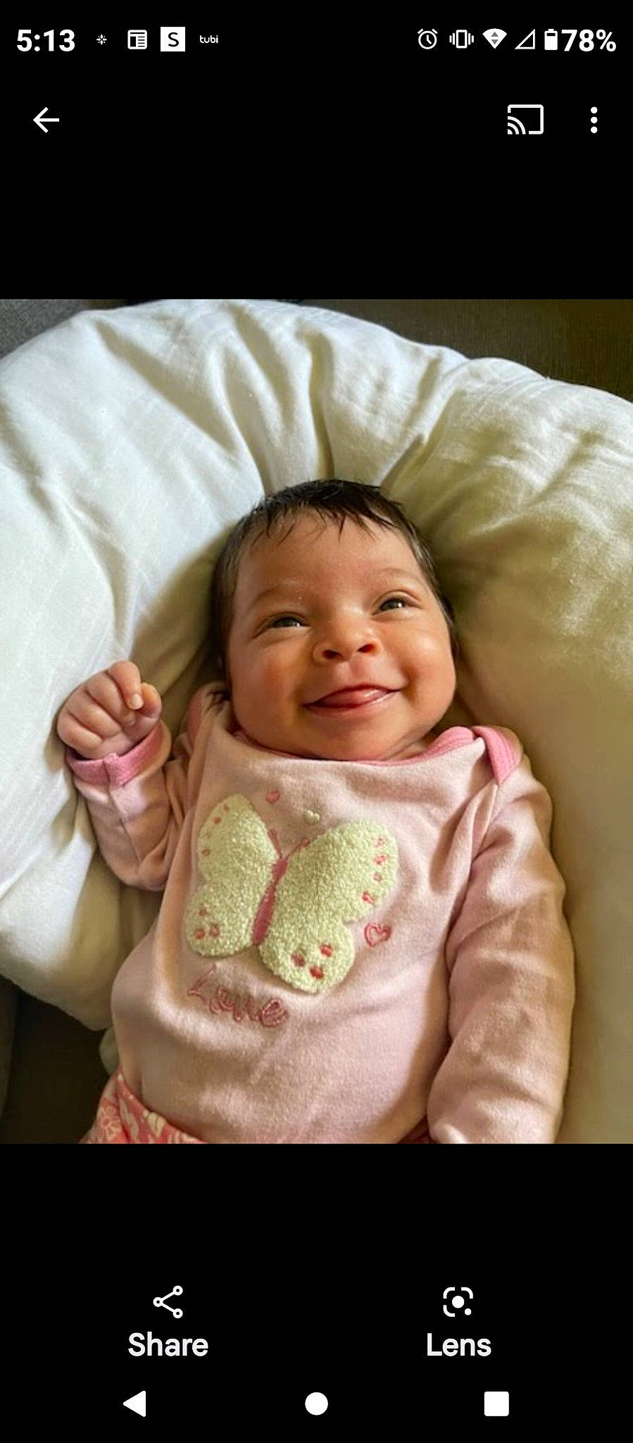 Amira is registered to the contest to win money with this photo: baby, baby_toddler_clothing, cheek, comfort, eyebrow, face, gesture, hair, happy, head, joy, linens, lip, mouth, nose, person, pink, skin, sleeve, smile