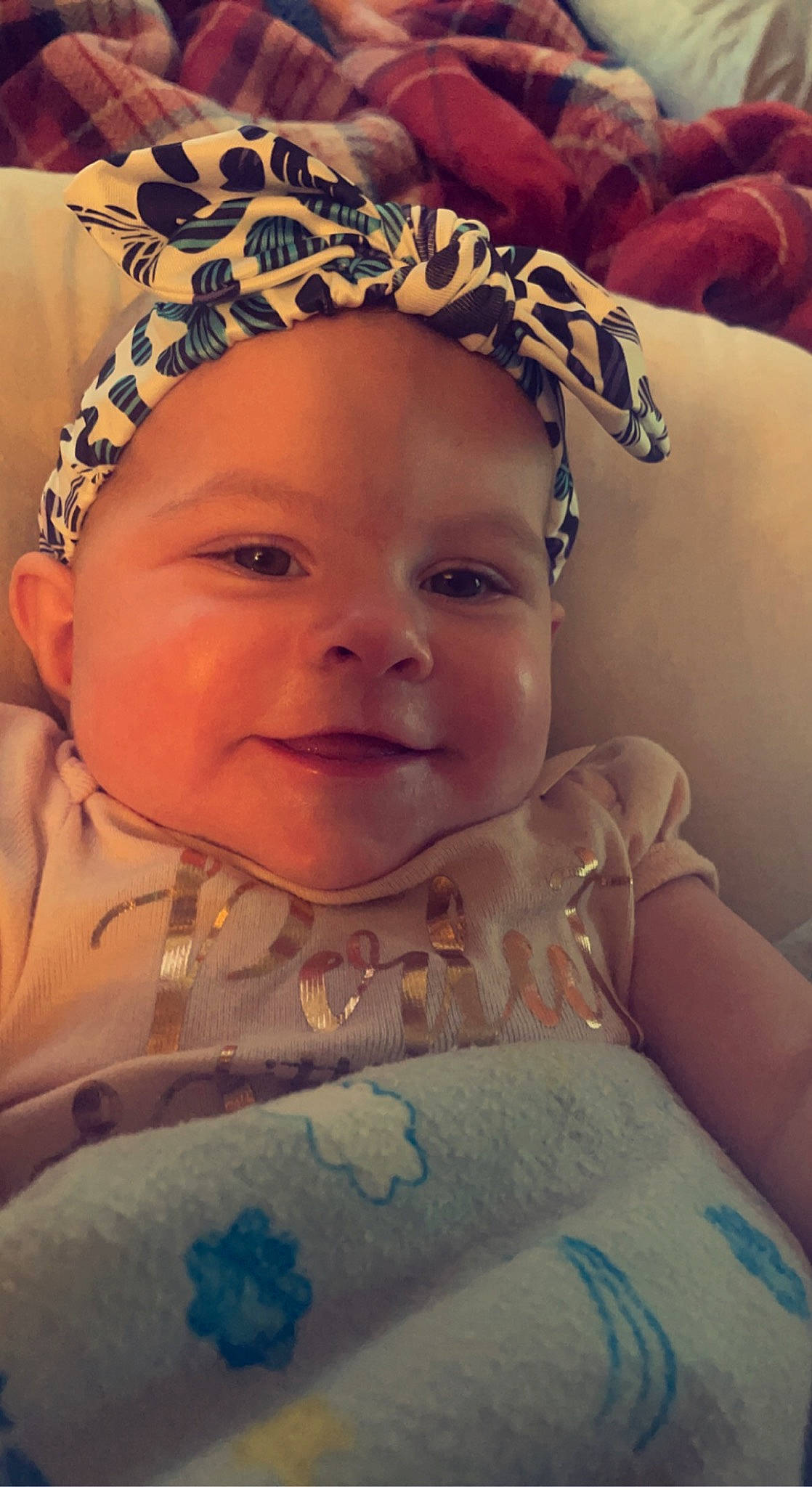 Dianna is registered to the contest to win money with this photo: baby, baby_toddler_clothing, blue, cheek, chin, cool, eye, eyebrow, face, happy, head, headwear, iris, lip, mouth, nose, person, pink, plant, skin