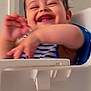 toddler, child, smiling, laughing, high_chair, striped_shirt, indoor, happy, baby, person, face, arm, hand, furniture, seat, joy, cute, young, playful, expression