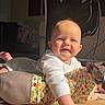 Oaklee is registered to the contest to win money with this photo: baby, child, infant, sphynx_cat, cat, pet, hairless_cat, floor, sunlight, indoor, pajamas, clothing, fruit_pattern, smiling, happy, person, animal, feline, home, cozy