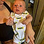 Kevan a rejoint le concours — aidez-le/la à gagner de superbes lots ! adult, arm, baby, batman, child, clothing, cute, expression, face, fingers, hand, holding, human, indoor, infant, light, onesie, person, portrait, skin