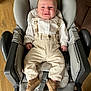 baby, child, clothing, cushion, footwear, furniture, happy, high_chair, indoor, infant, pants, person, portrait, relaxing, seat, shirt, shoes, smile, suspenders, wood_floor