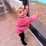 Wren joined the competition — help win amazing prizes! baby, child, girl, bow, pink_sweater, black_tights, standing, glass_door, pool, outdoor, smile, happy, headband, window, floor, reflection, person, cute, portrait, toddler
