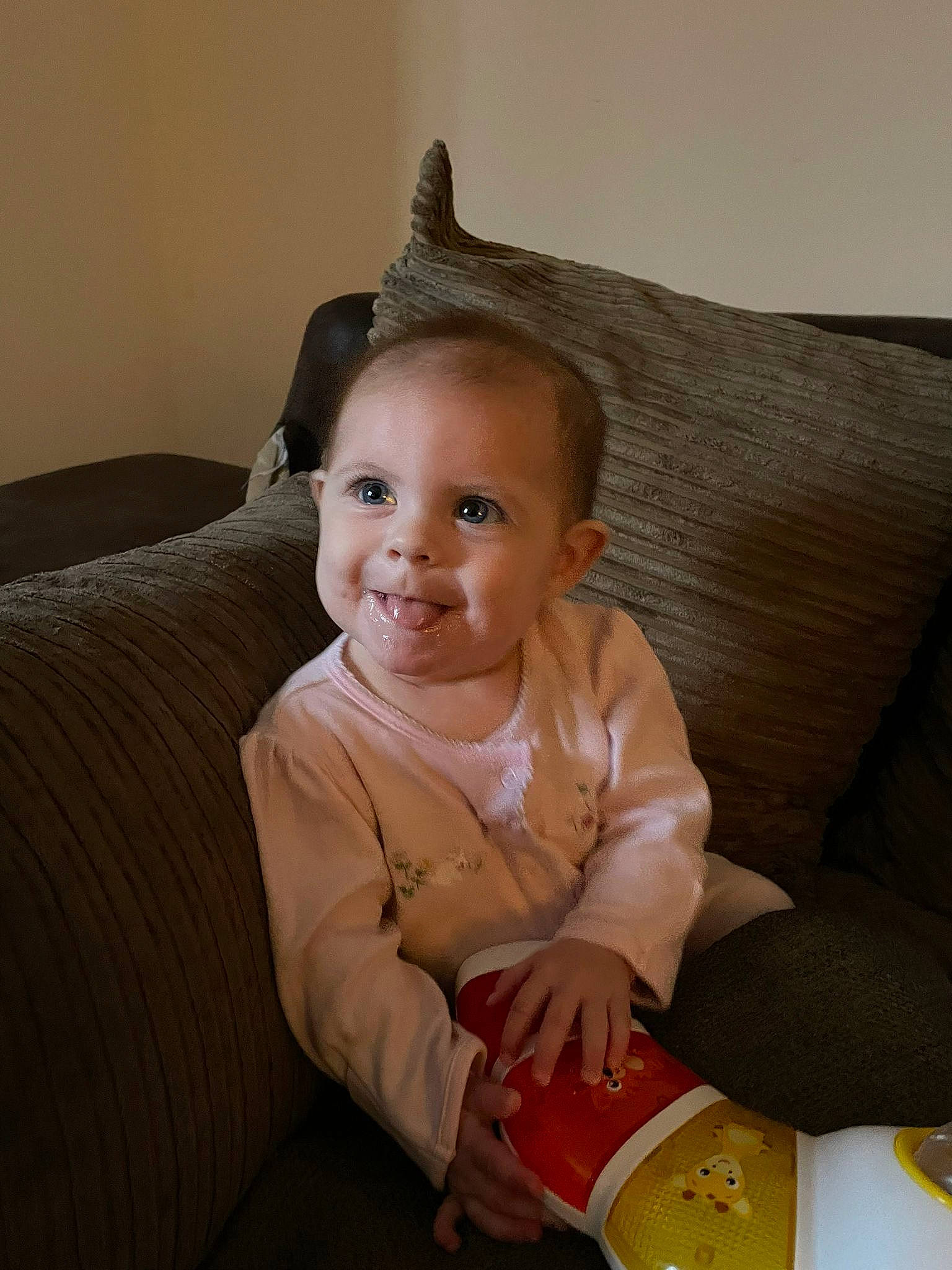 Isabella-rose is registered to the contest to win money with this photo: baby, baby_toddler_clothing, cheek, child, comfort, couch, finger, flooring, fun, hairstyle, happy, head, joy, lap, lip, person, room, sitting, skin, sleeve