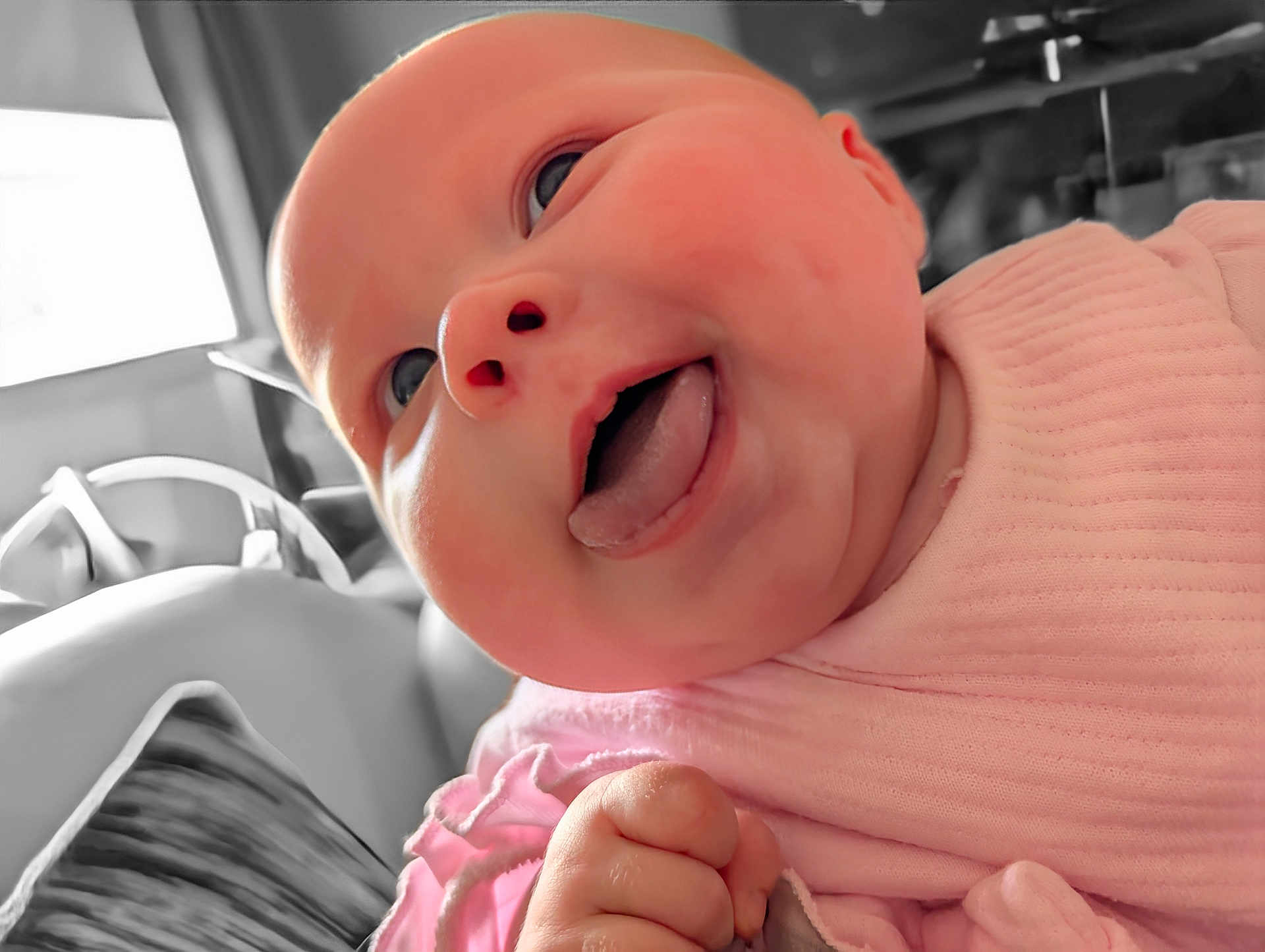 Ivy is registered to the contest to win money with this photo: baby, face, tongue, pink_clothing, closeup, infant, child, happy, cute, skin, hand, expression, indoors, portrait, head, chubby_cheeks, soft_light, smile, person, candid