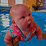 Ivy joined the competition — help win amazing prizes! baby, child, pool, water, swimming, floatation_vest, person, indoor, blue, arm, hand, cute, expression, face, skin, holding, splash, fun, infant, play