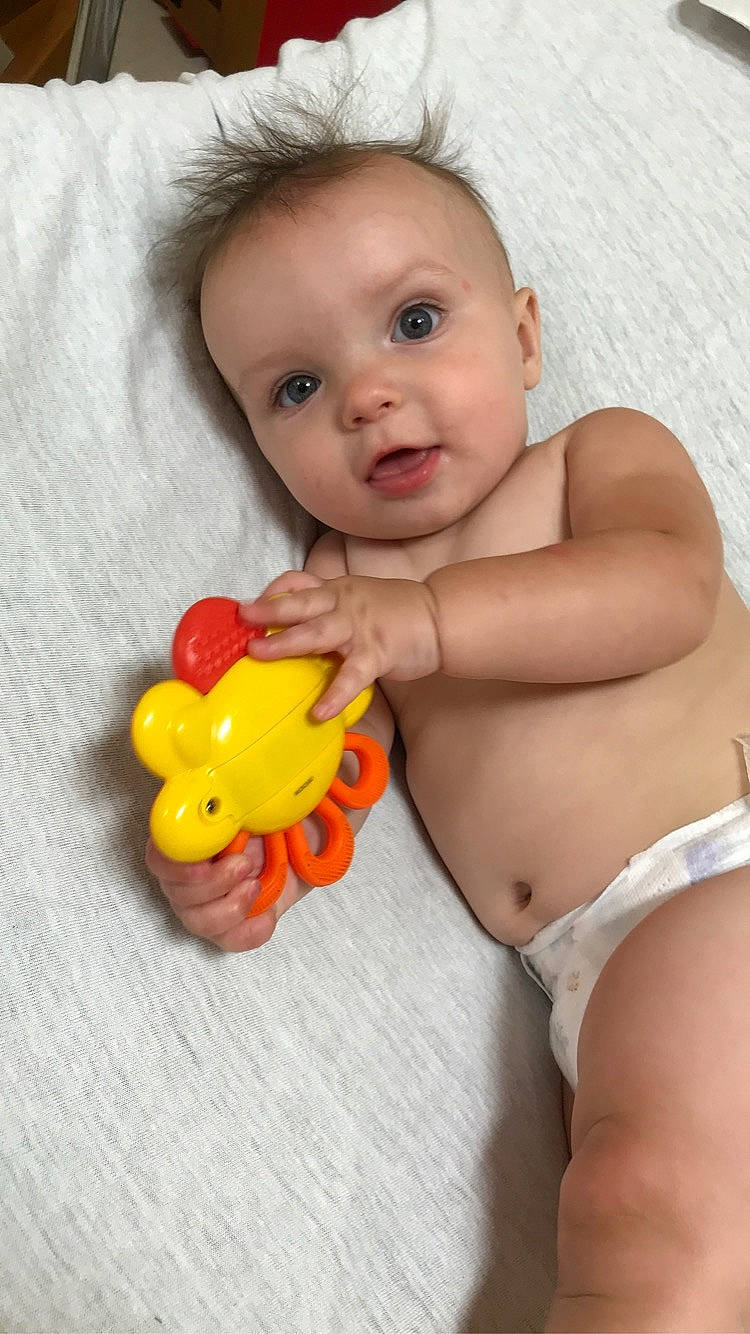 Jaxson is registered to the contest to win money with this photo: arm, baby, cheek, chin, eye, face, finger, hair, hand, head, human_body, iris, joint, lip, mouth, neck, nose, organ, person, product