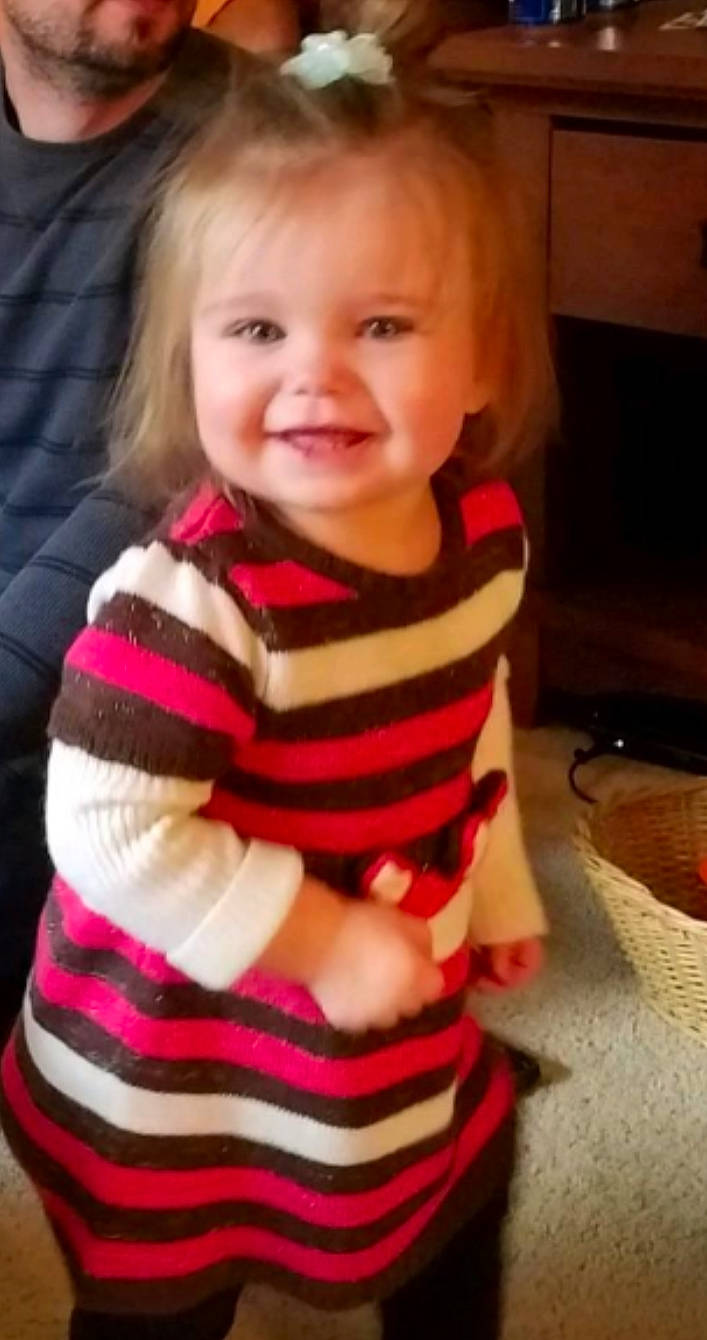 Reagan is registered to the contest to win money with this photo: arm, baby, beauty, blond, cheek, child, cool, eye, face, facial_expression, head, joy, lip, nose, outerwear, person, pink, product, sitting, skin