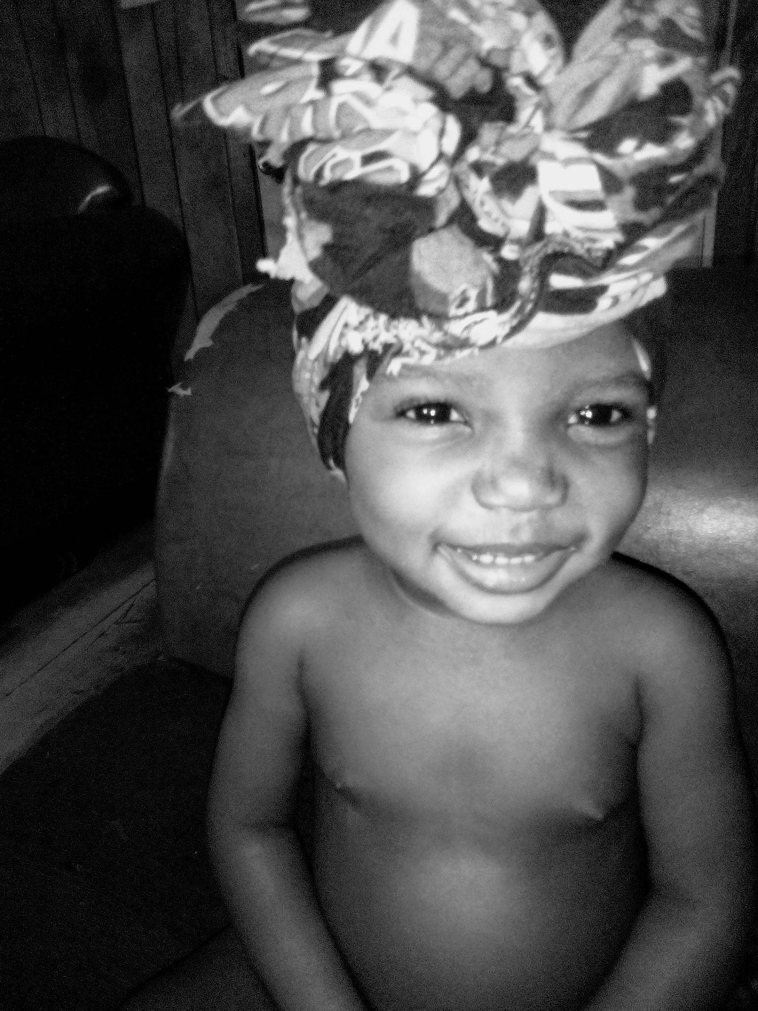 Chloe is registered to the contest to win money with this photo: baby, black_and_white, child, eye, face, facial_expression, fashion_accessory, fun, hair_accessory, head, headgear, headpiece, headwear, monochrome, monochrome_photography, person, photograph, photography, plant, smile