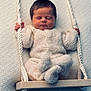 newborn, baby, sleeping, knitted_outfit, swing, rope, wooden_swing, cozy, soft_texture, peaceful, infant, child, cute, hands, feet, portrait, indoors, warm, resting, adorable
